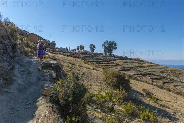 Local woman carrying child on her back