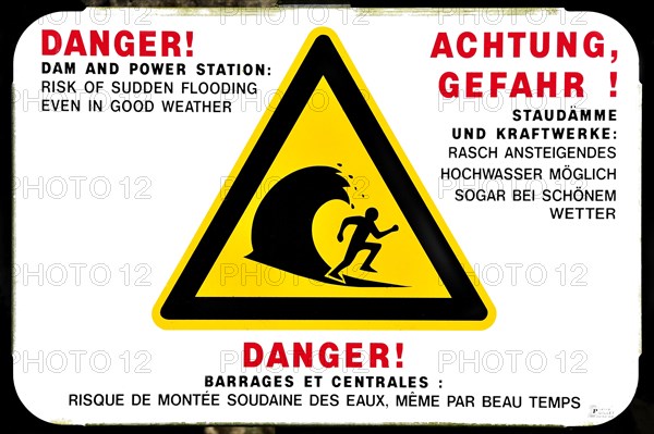 Warning sign for sudden flooding of river by dam from power station