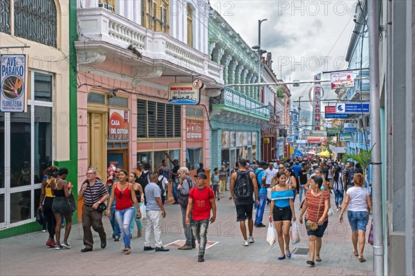 Streetscene showing shops and Cuban shoppers in shopping street in Santiago de Cuba