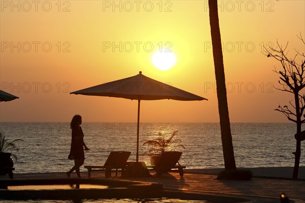 Parasol and woman in evening sun