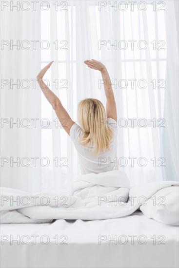 Lovely senior woman waking up morning