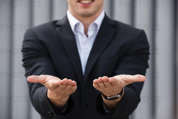 Businessman holding his hands out