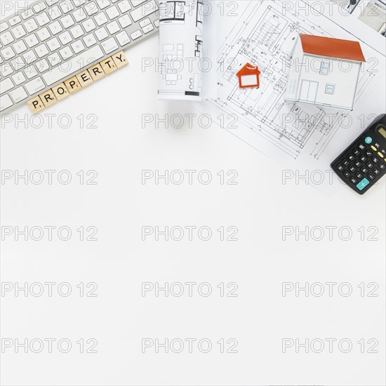 Keyboard with house model blueprint real estate office desk