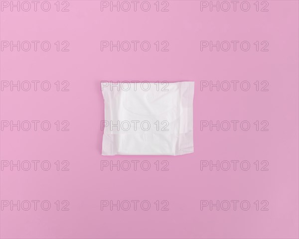 Closed sanitary towel pink background