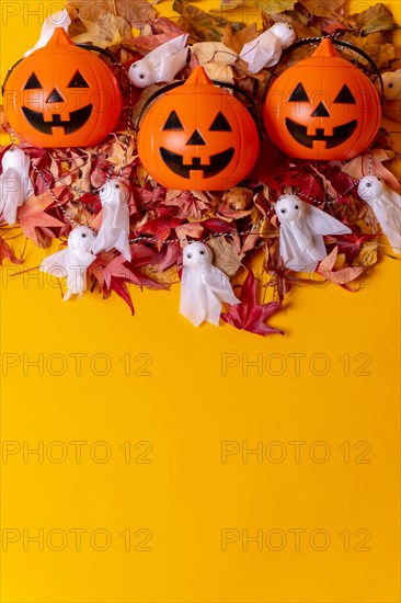 Overhead view of orange Halloween pumpkins on a background of yellow