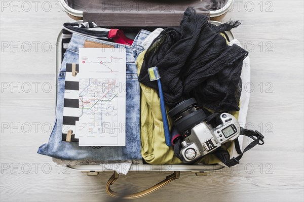 Top view female s travelling bag with camera brush map