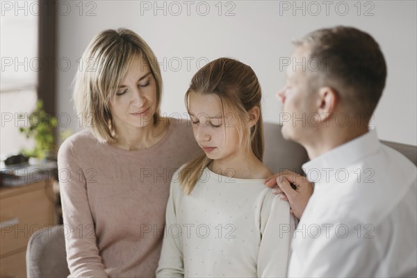 Parents daughter praying together