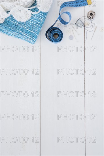 Crochet knitted fabric measuring tape pushpin thimble thread button wooden table