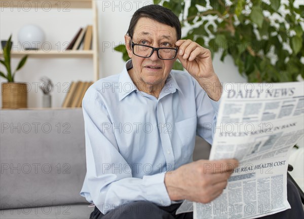 Medium shot man holding newspaper