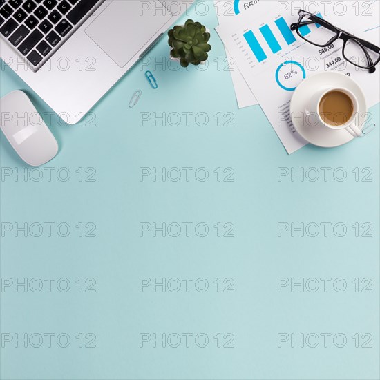 Mouse laptop cactus plant eyeglasses budget plan coffee cup blue background