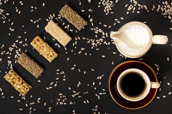 Flat lay cereal bars assortment with milk coffee plain background