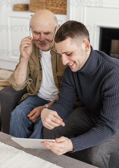 Medium shot men looking tablet