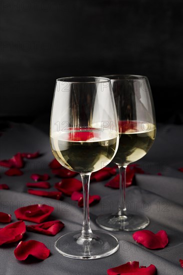 Valentine s day rose petals with wine glasses