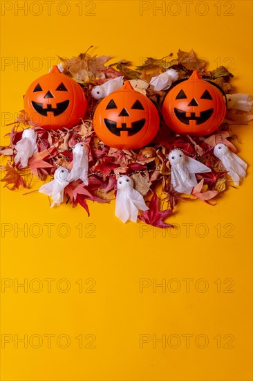Overhead view of orange Halloween pumpkins on a background of yellow