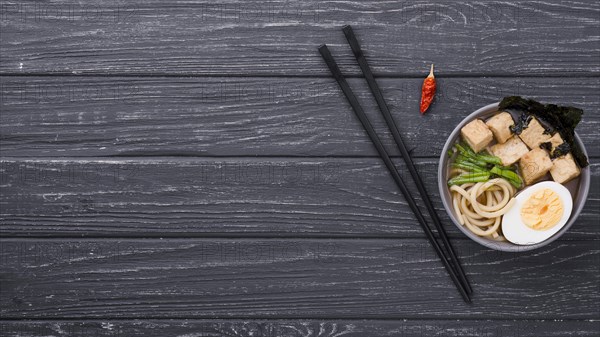 Top view ramen healthy soup with egg chopsticks