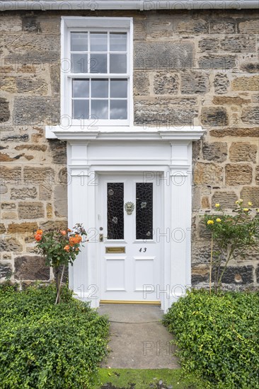 White front door on an old stone house