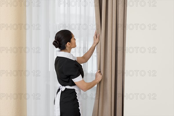 Chambermaid cleaning hotel room