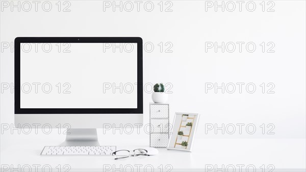 Keyboard near monitor frame cactus eyeglasses table