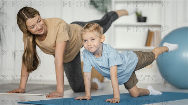 Full shot woman kid exercising together
