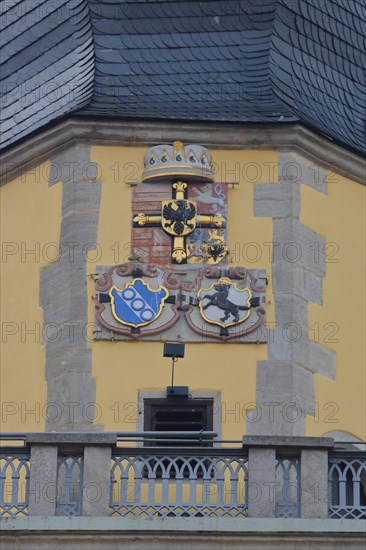 City coat of arms and parapet on the tower of St. John's Minster