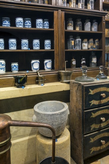 Antique pharmacy cabinet with vintage jars at the Orval Abbey
