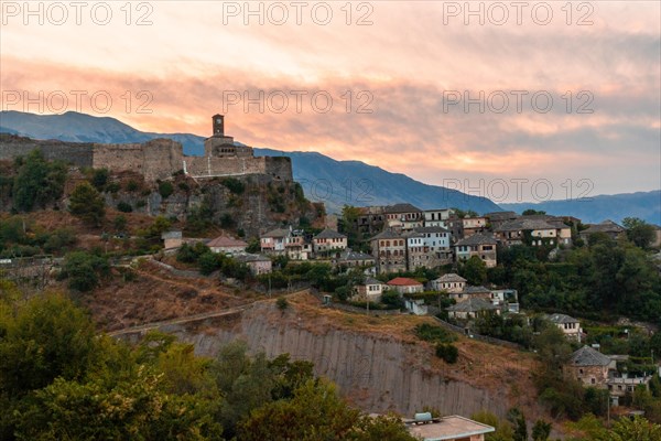 Sunset over the clock tower and fortress of Gjirokaster