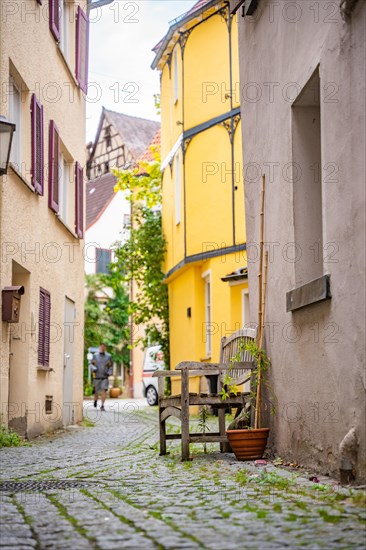 Narrow alleyway alley with wooden bench