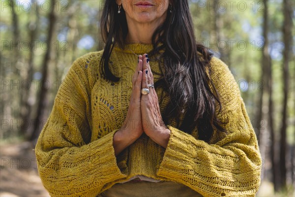 Close up of woman's clasping hands outdoors