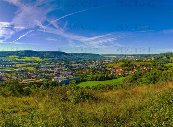 View over the city of Jena from the Galgenberg with the Kernberge in the background under blue sky and veil clouds