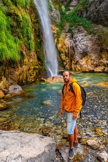 Hiker at Grunas waterfall in Theth national park