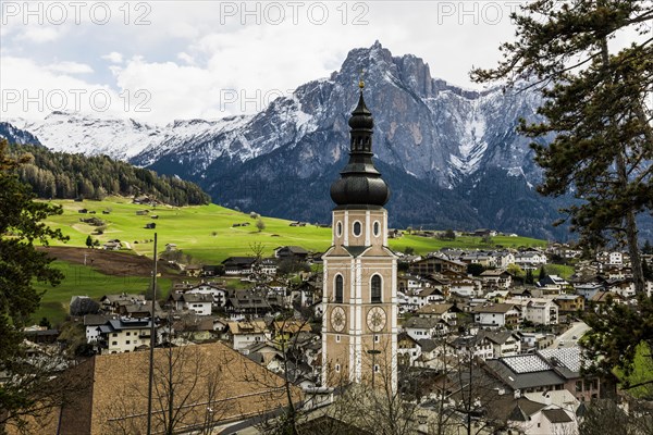 Village and snow-capped mountains