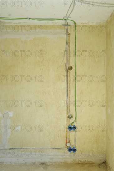 Power and network cables on a wall