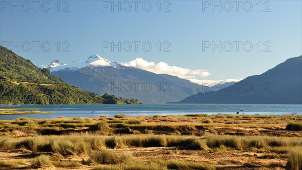 The Estero Reloncavi near Cochamo in southern Chile with the snow-capped volcano Yate