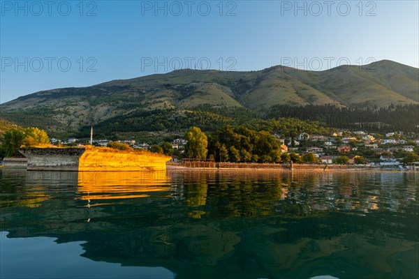 View of the city of Shiroka from the lake on a traditional boat on a sightseeing excursion from Shkoder. Albania