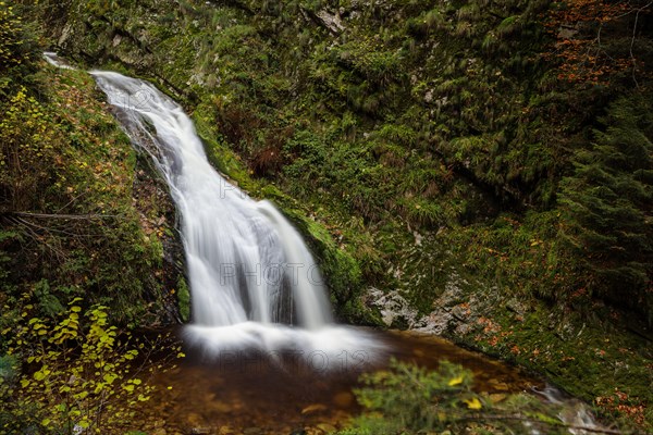 Mountain stream with waterfalls in autumn
