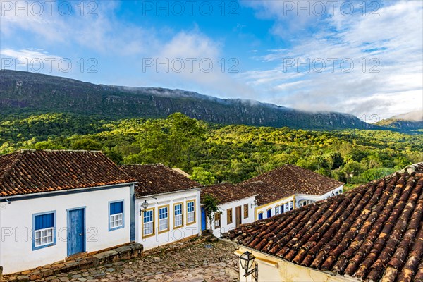 Quiet street in the historic city of Tiradentes with its old colonial-style houses and the mountain in the background