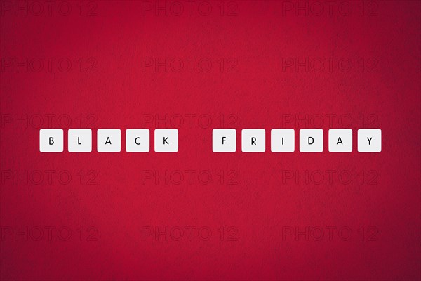 Black friday illustration composition. Text on board game chips. Red textured background