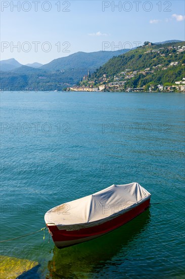 One Boat on the Waterfront in a Sunny Summer Day and on Lake Lugano and Mountain View over Morcote