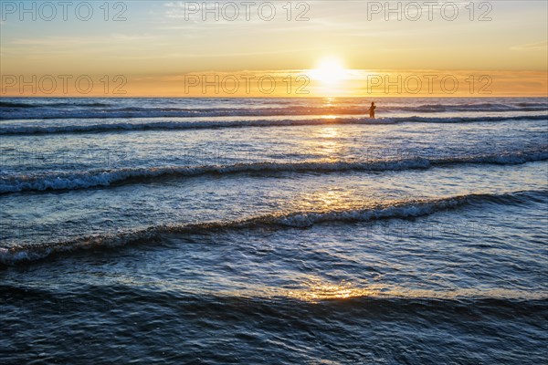 Atlantic ocean sunset with surging waves at Fonte da Telha beach