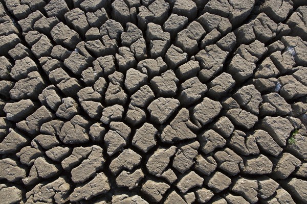 Abstract pattern of dry cracked clay mud in dried up lake bed