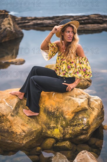 Caucasian blonde girl in a floral shirt