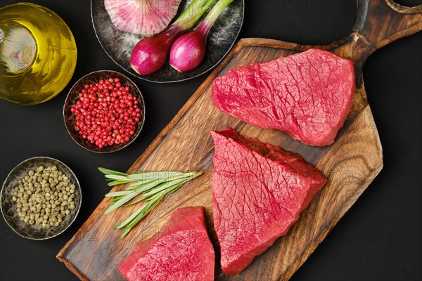 Flat lay composition with raw beef strip steak boneless