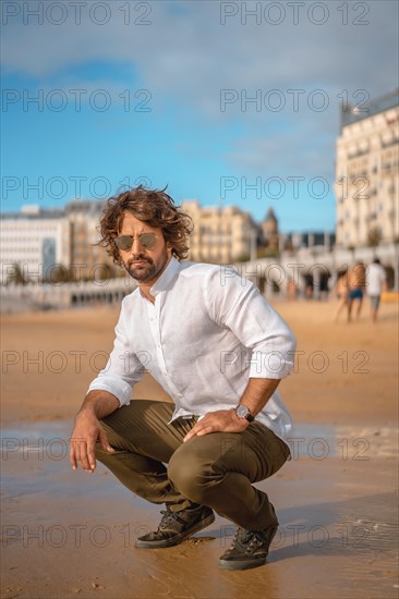 Summer lifestyle with a young dark-haired Caucasian man with long beard