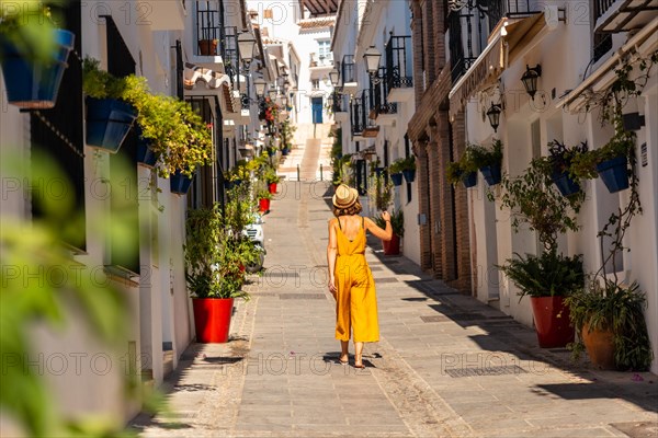 A tourist in Mijas visiting the white houses and charming town and the slopes in Malaga. Andalusia