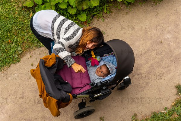 A mother with her baby in the gardens of the Abbaye de Beauport in the village of Paimpol