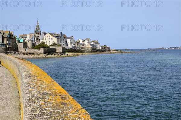 Old town with buildings and church tower by the sea