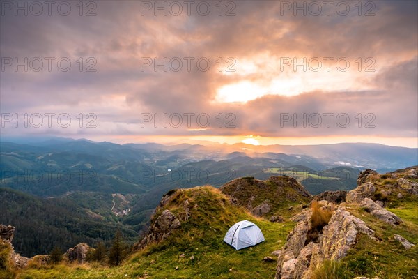 Wild camping on the top of a mountain at sunset