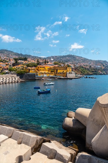 Small fishing boats next to the Forte de Sao Tiago on the beach of Funchal
