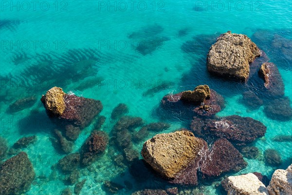 Detail of the sea and rocks on Calahonda beach in the town of Nerja