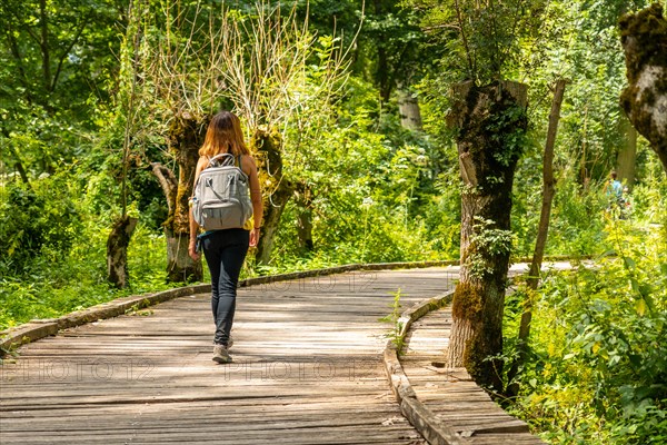 A young woman walking on the trek on the trail between La Garette and Coulon